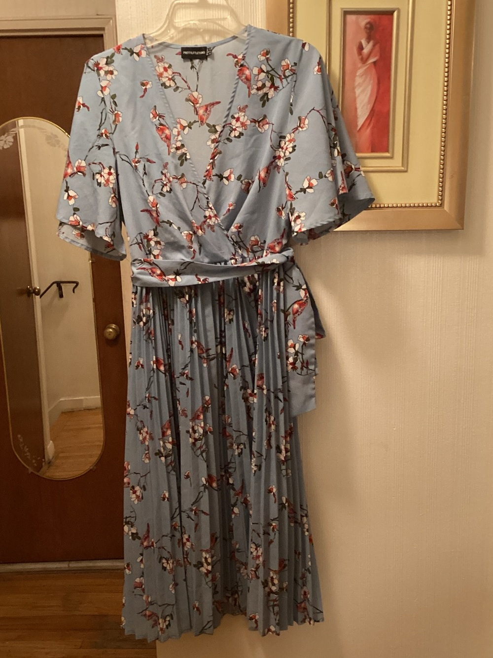 PrettyLittleThing Light Blue Floral Wrap Pleated Midi Dress with Red Accents.